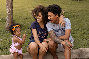 Happy black family near lawn with green grass