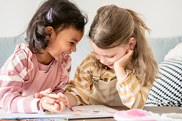 happy girls painting together